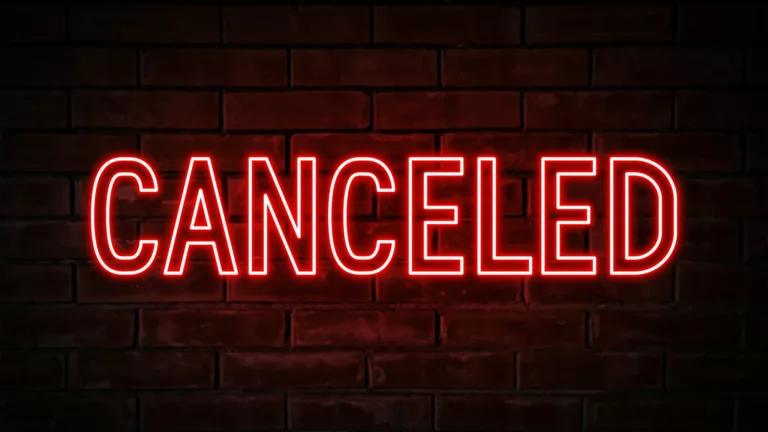Canceled - red neon light word on brick wall background